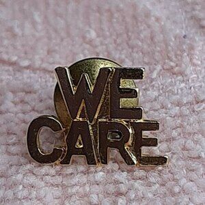 Vintage gold-tone "WE CARE" lapel hat pin - small text words